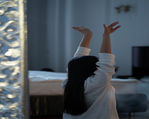 Person doing morning stretching rituals outdoors